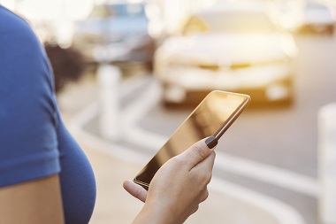 woman using smartphone for collision repair photo estimate